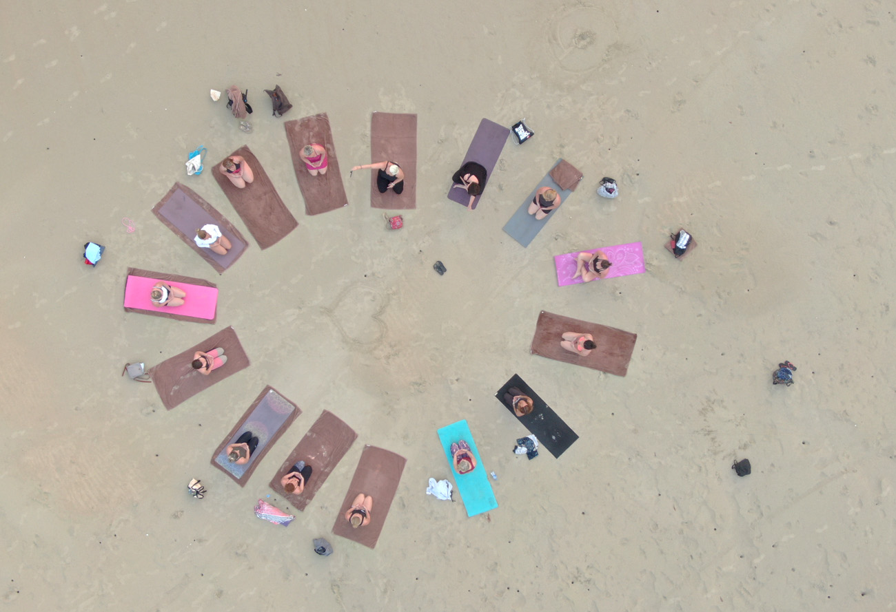 Foreign tourists practice early-morning yoga in fresh air