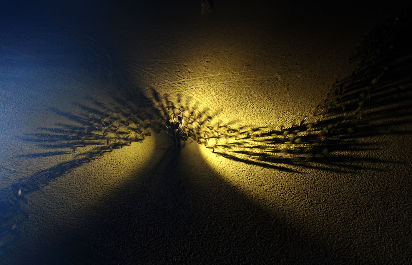 Groups carrying out team-building activities at night on the beach