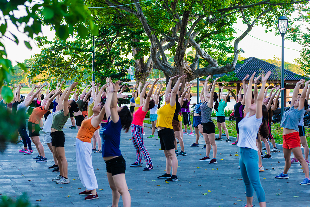 Doing exercise at the park on the bridgehead attracts many women