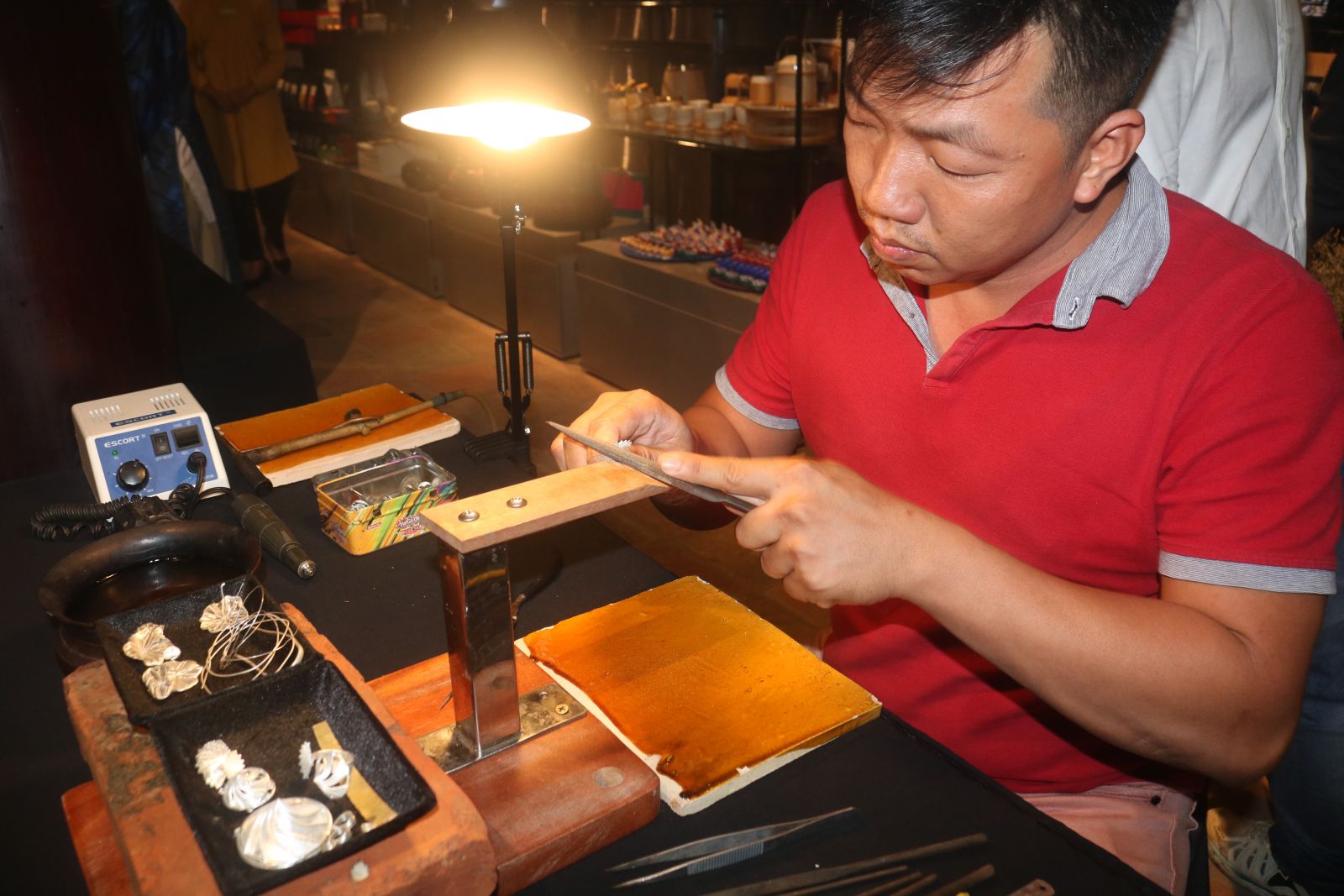 An artisan demonstrating the jewelry making process