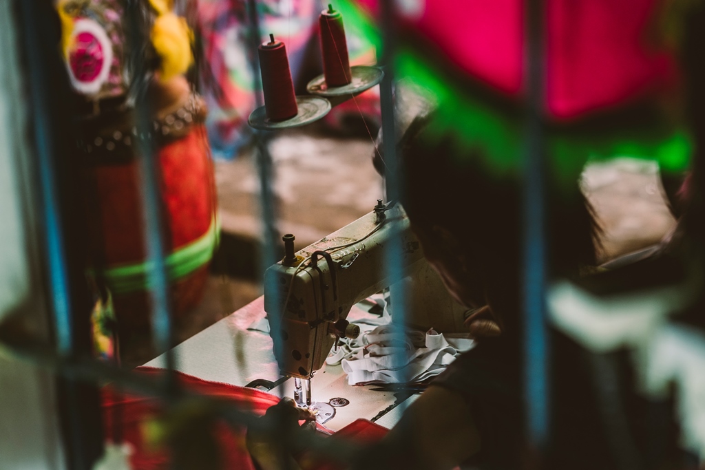 Meticulously sewing costumes