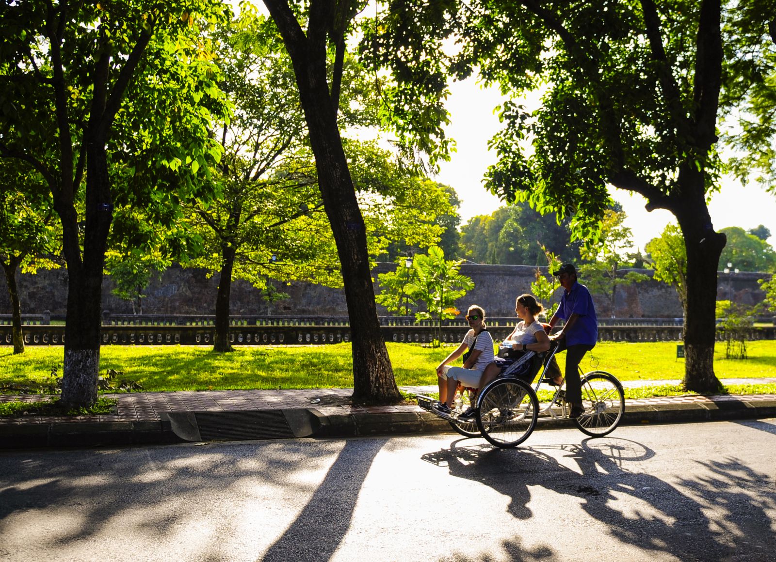 Foreign tourists on Hue’s cyclos, admiring the autumn sun