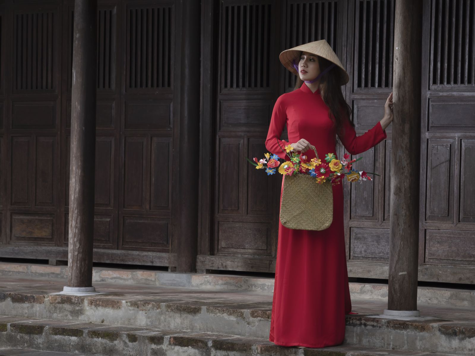 Red ao dai at an ancient house