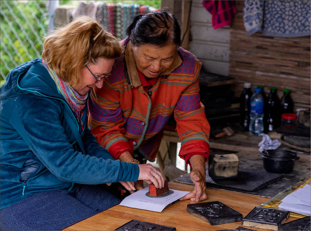 Visitors experience the woodblock printing of Sinh village and making incense