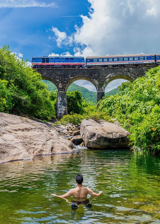Guests take a dip in a small stream near Hai Van Station