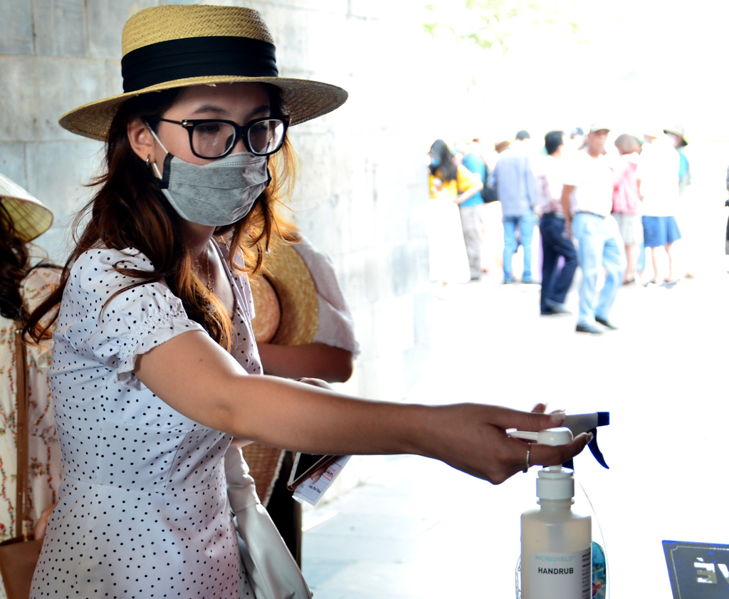 Disinfecting hands before visiting the heritage