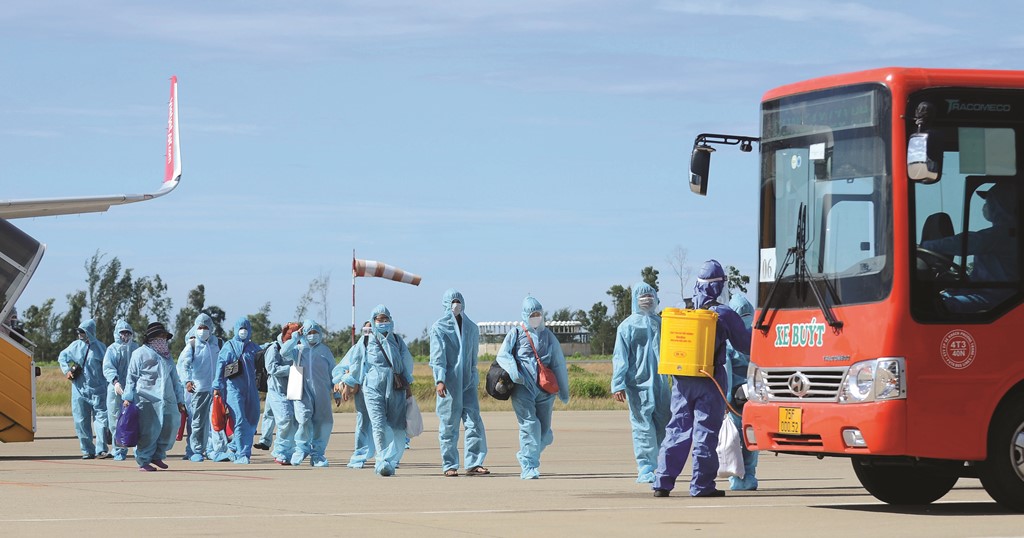 After returning from pandemic-hit areas, people are disinfected before moving to quarantine areas