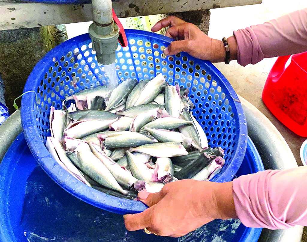 The fish is decapitated, slaughtered, and rinsed before being deboned