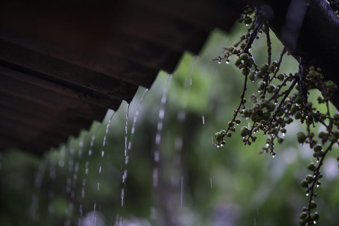 Dripping rain falling on the deserted porch