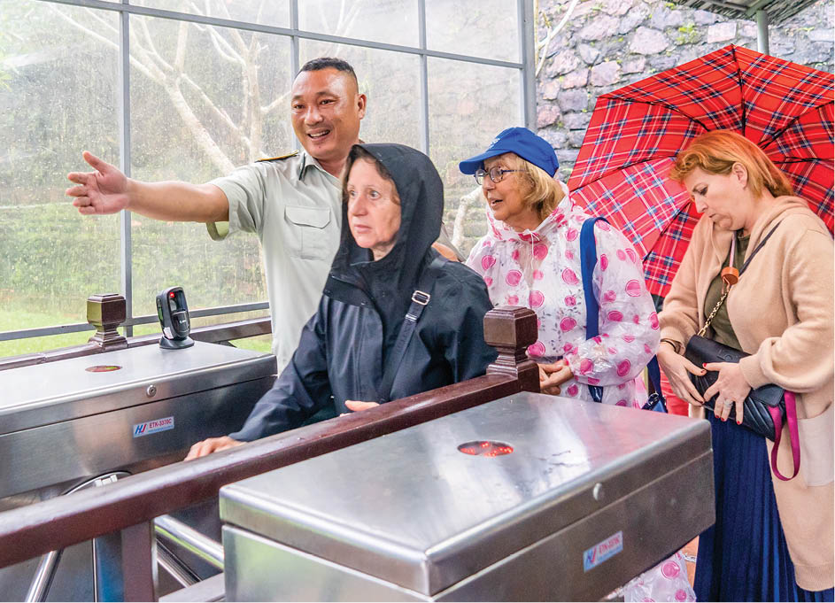 The staff at Tu Duc royal mausoleum welcoming and guiding tourists to enter the relic