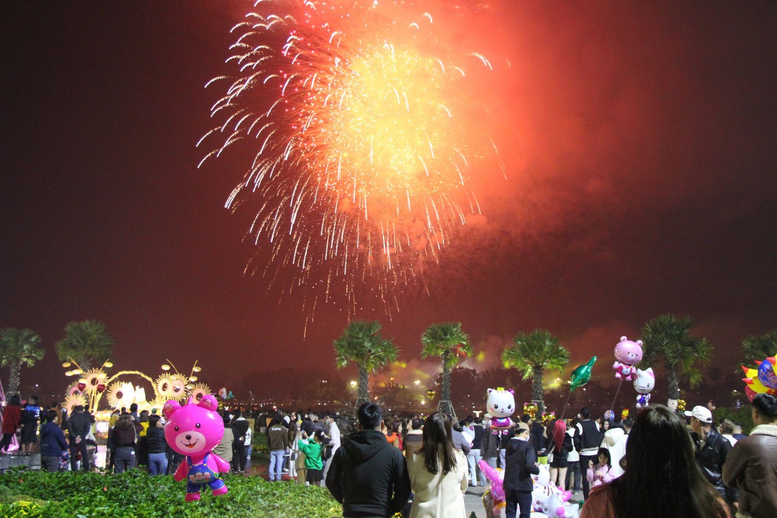 People watching New Year's Eve fireworks by the Huong River