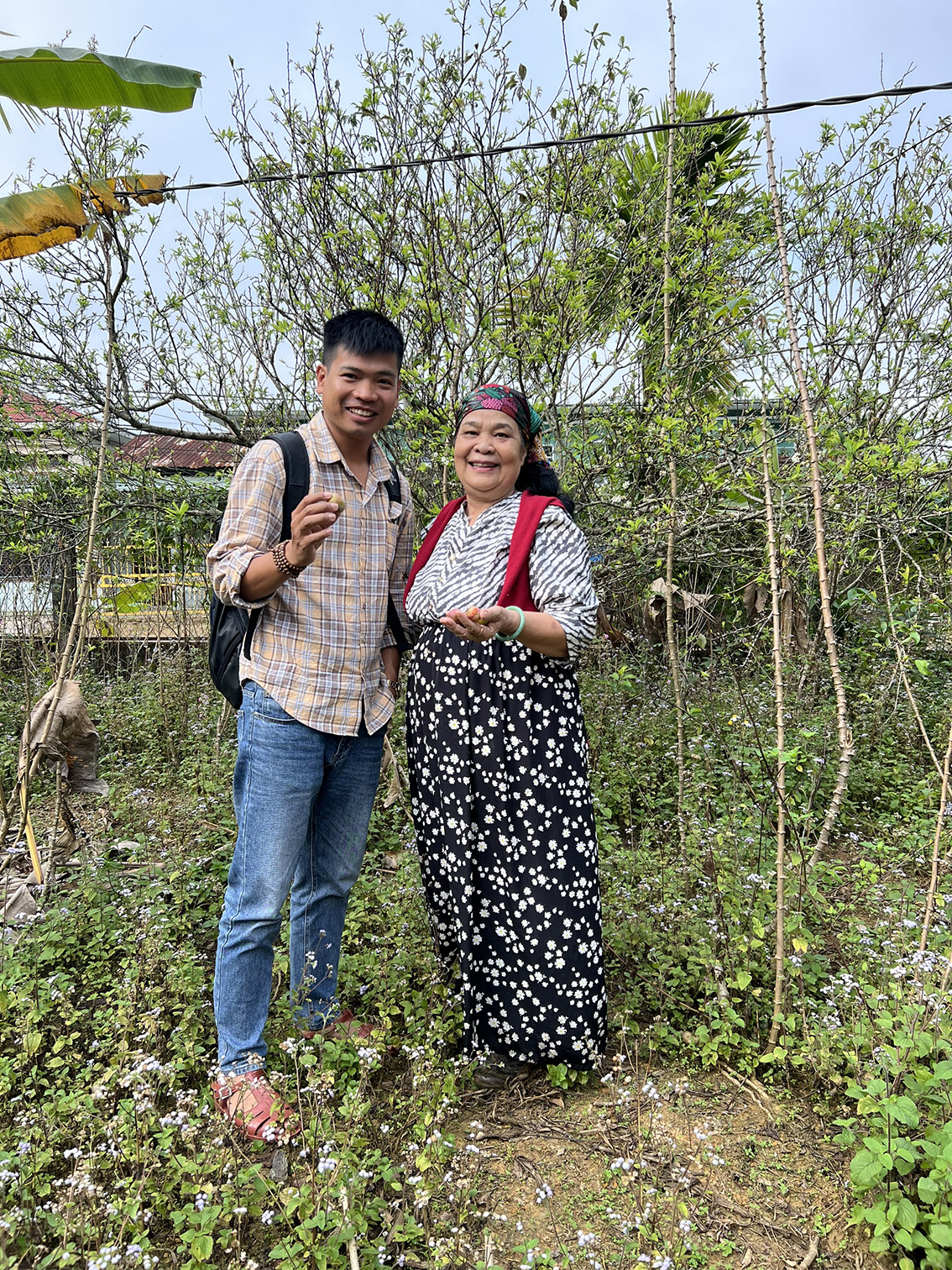 The garden owner is excited to pose for photo with tourists