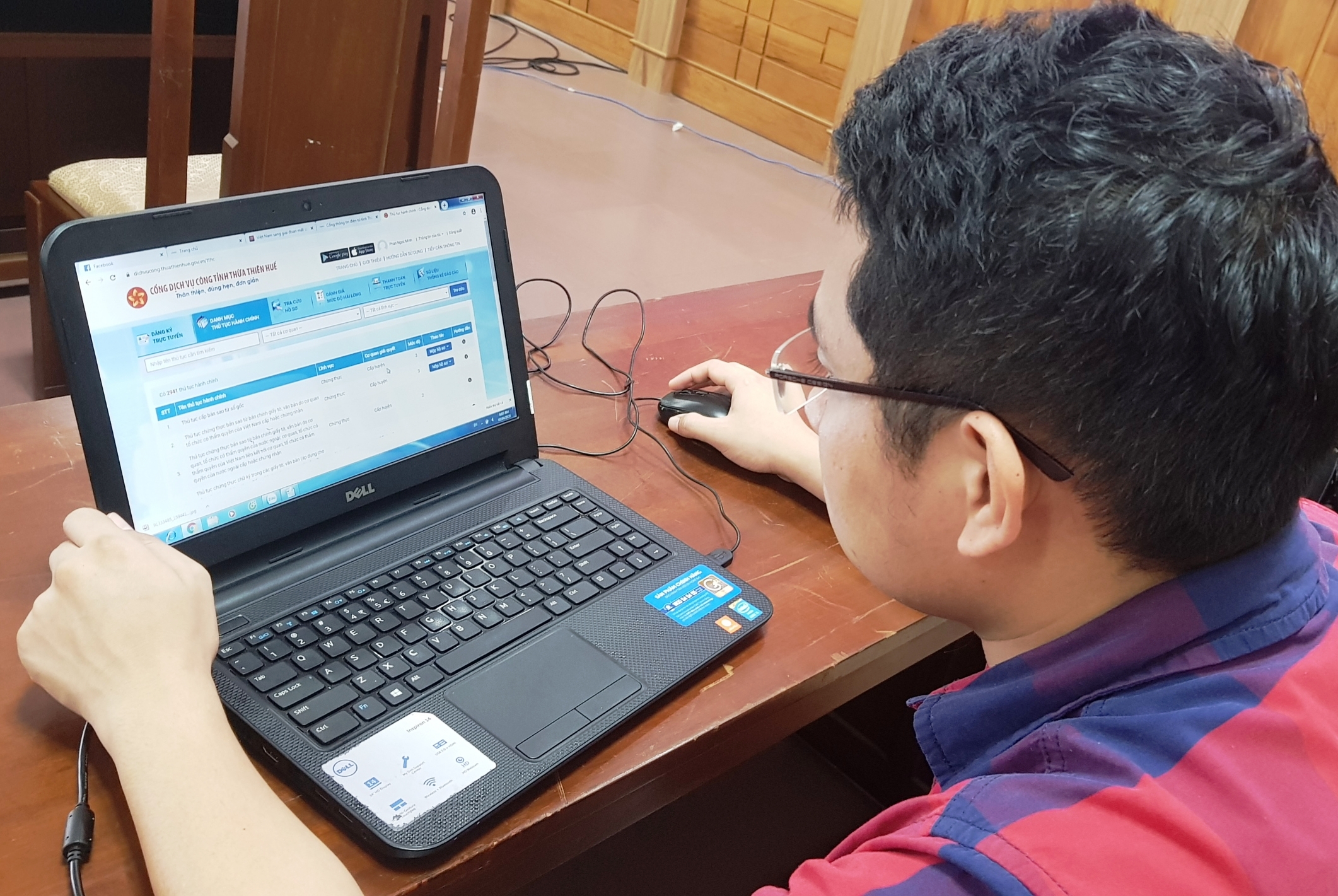 Ngồi ở nhà giao dịch thủ tục hành chính trực tuyến
