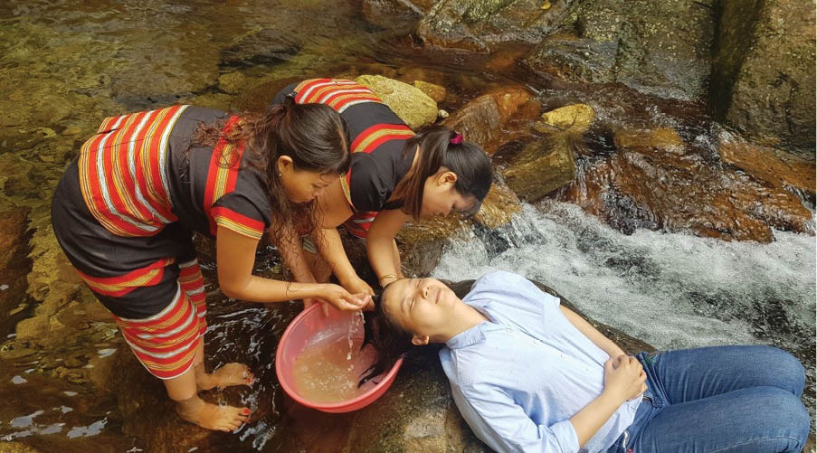 Washing hair, fumigating teeth by A Nor waterfall